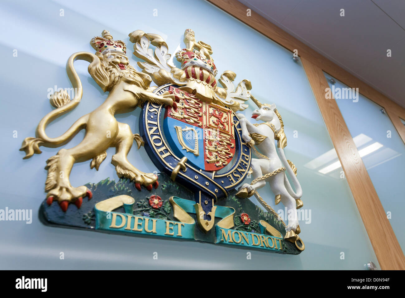 The shield of the Coat of Arms of the United Kingdon behind a Law Court bench. Stock Photo