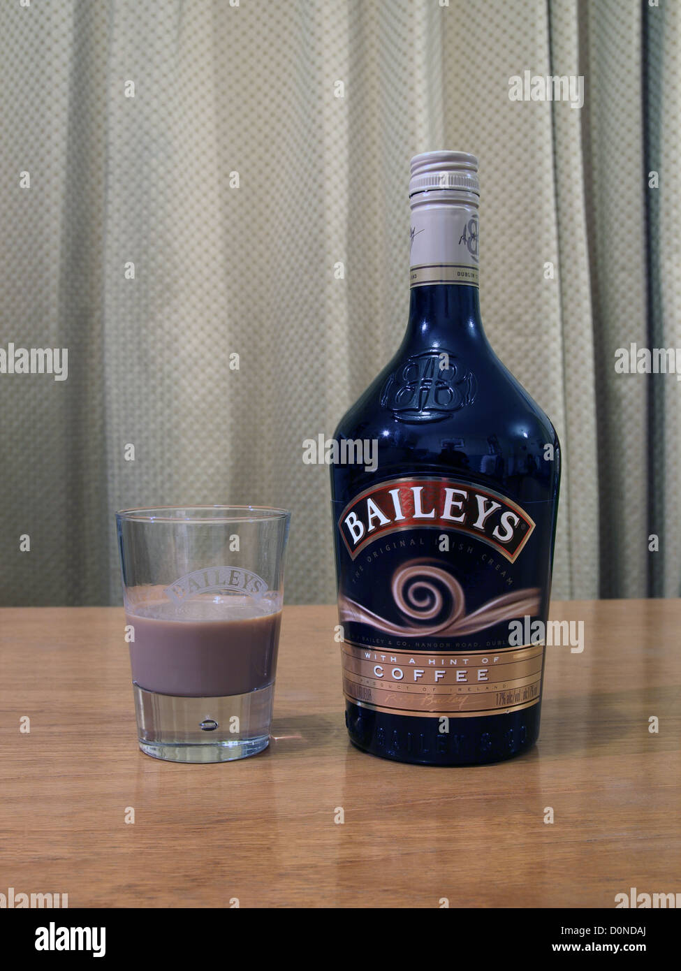 Bottle and Glass of Baileys Irish Cream Liqueur ( Coffee Variety ) Stock Photo