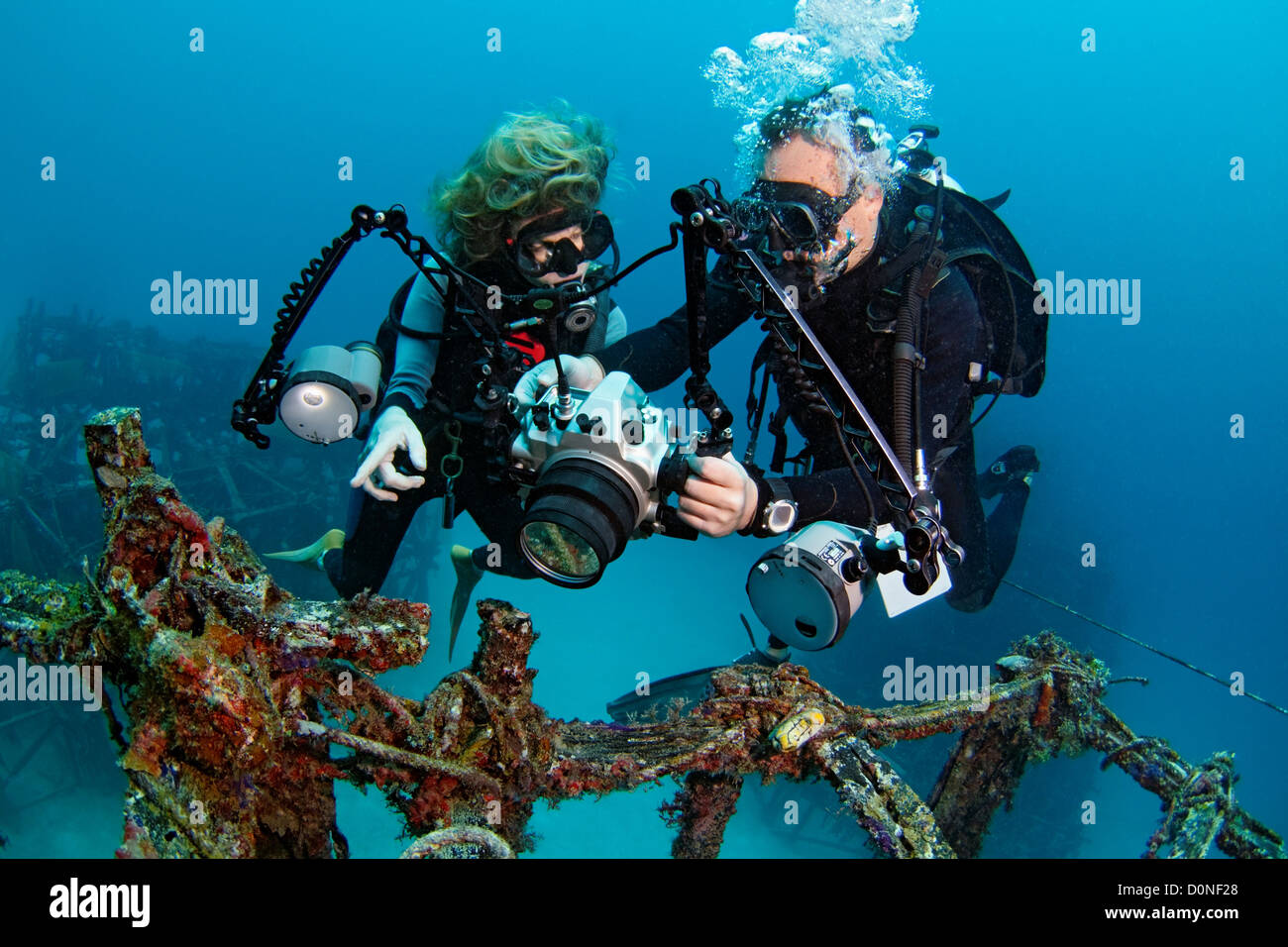 An instructor demonstrates proper underwater photography techniques