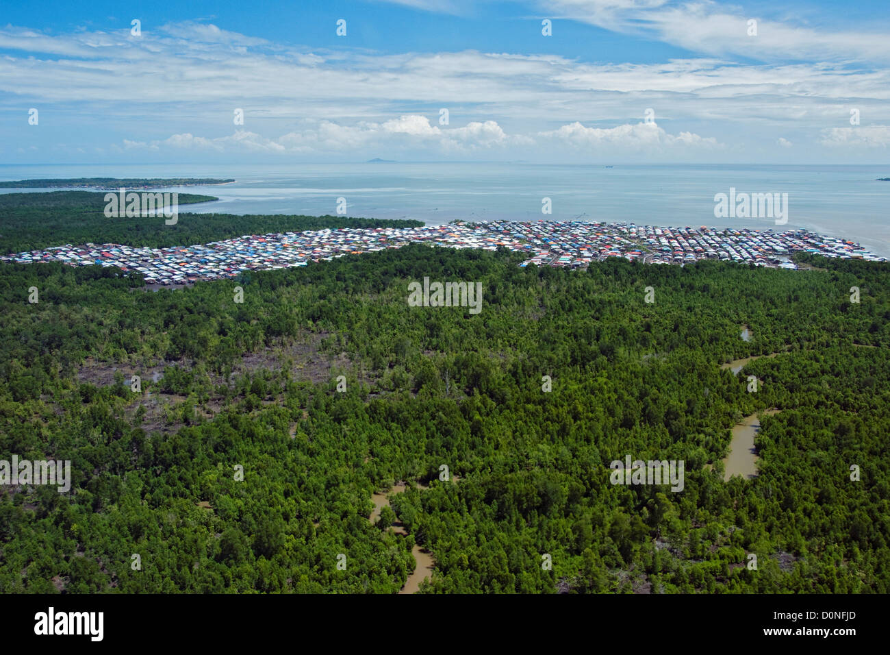 A tightly packed settlement borders wetlands in Sandakan, Sabah, Malaysia. Stock Photo