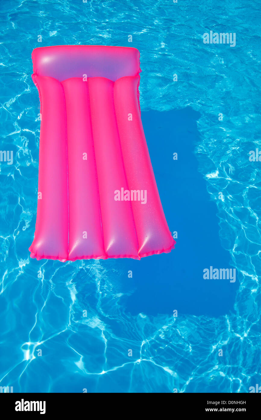 Pink Air Bed Floating On A Swimming Pool Stock Photo Alamy