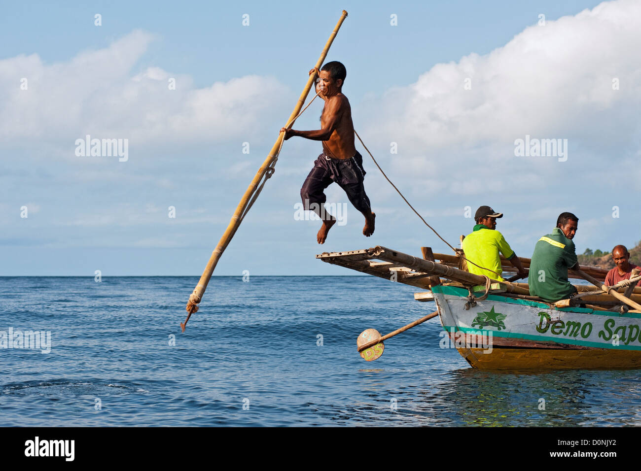 A traditional method of leaping from a boat platform to harpoon a whale, Lamalera, Lembata Island, Eastern Indonesia. Stock Photo