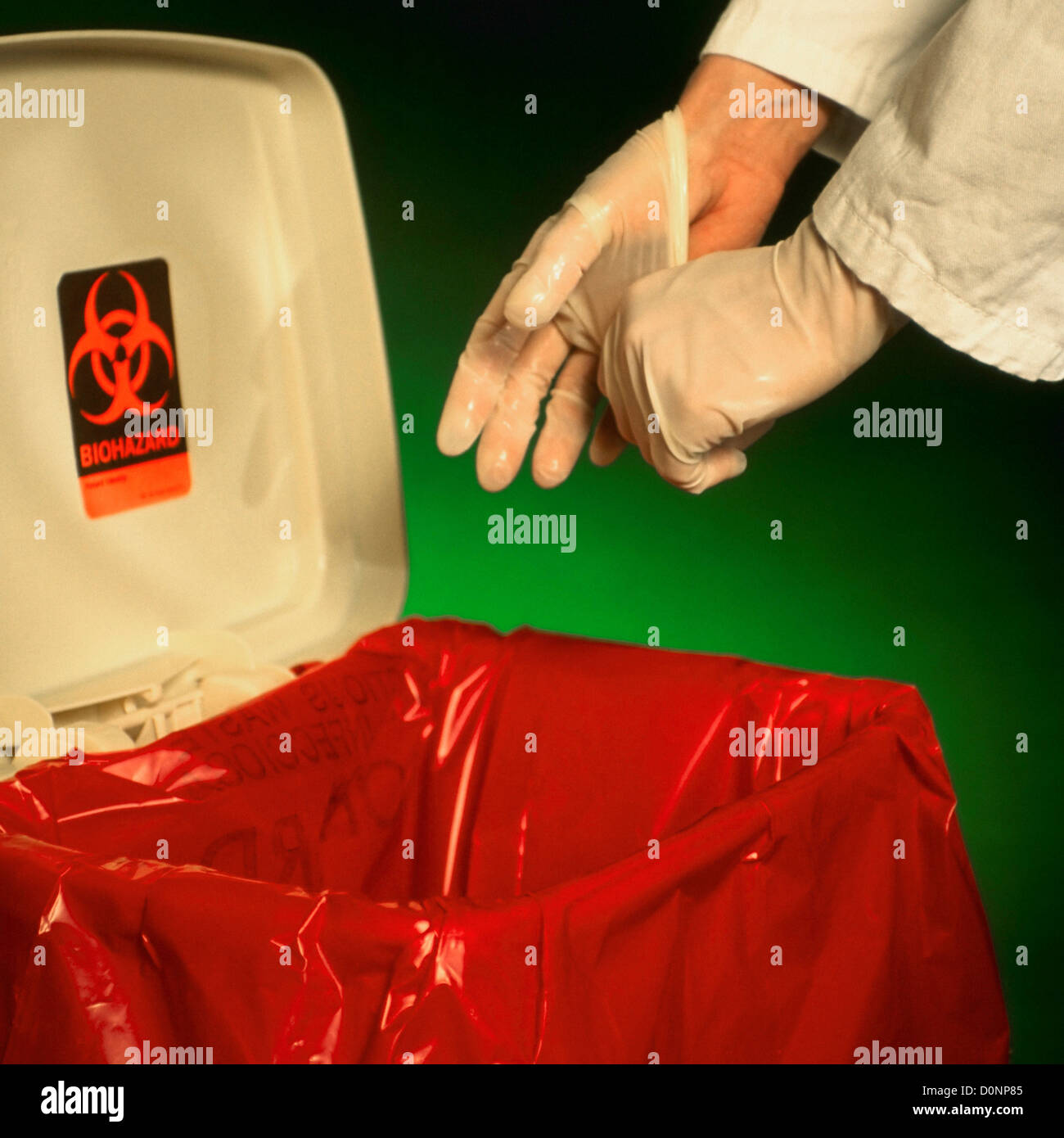 A Health Care Worker Puts Used Latex Gloves into a Biohazardous Waste