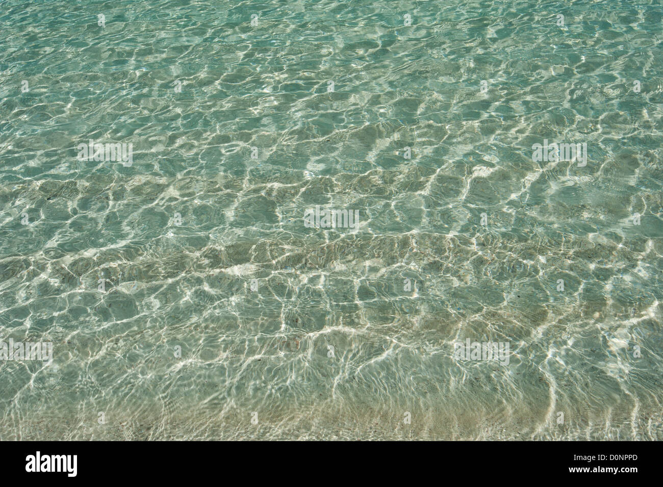 Light refraction through rippling water in a tropical sandy lagoon creating a background wallpaper Stock Photo