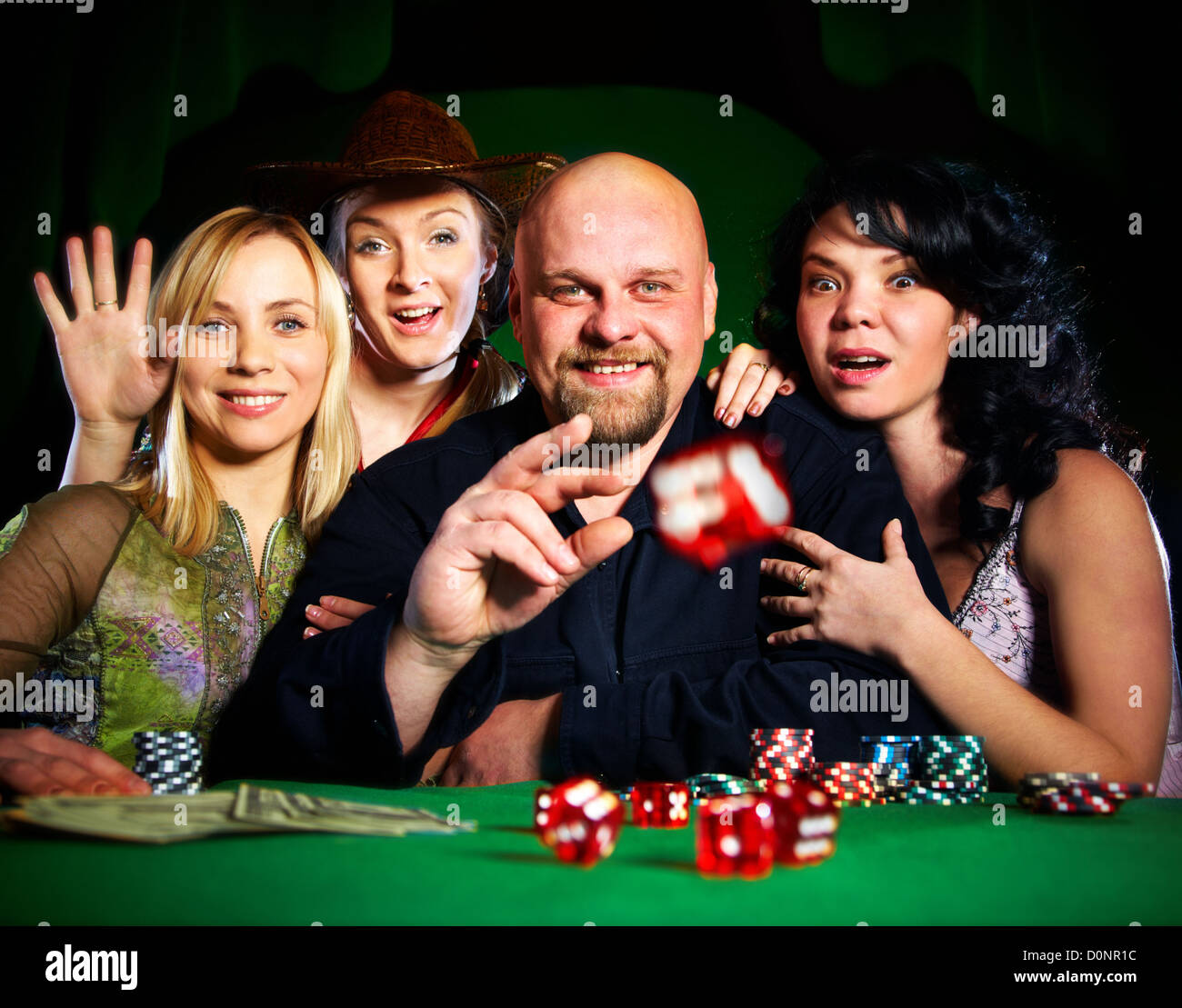 company of friends plays dice Stock Photo Alamy