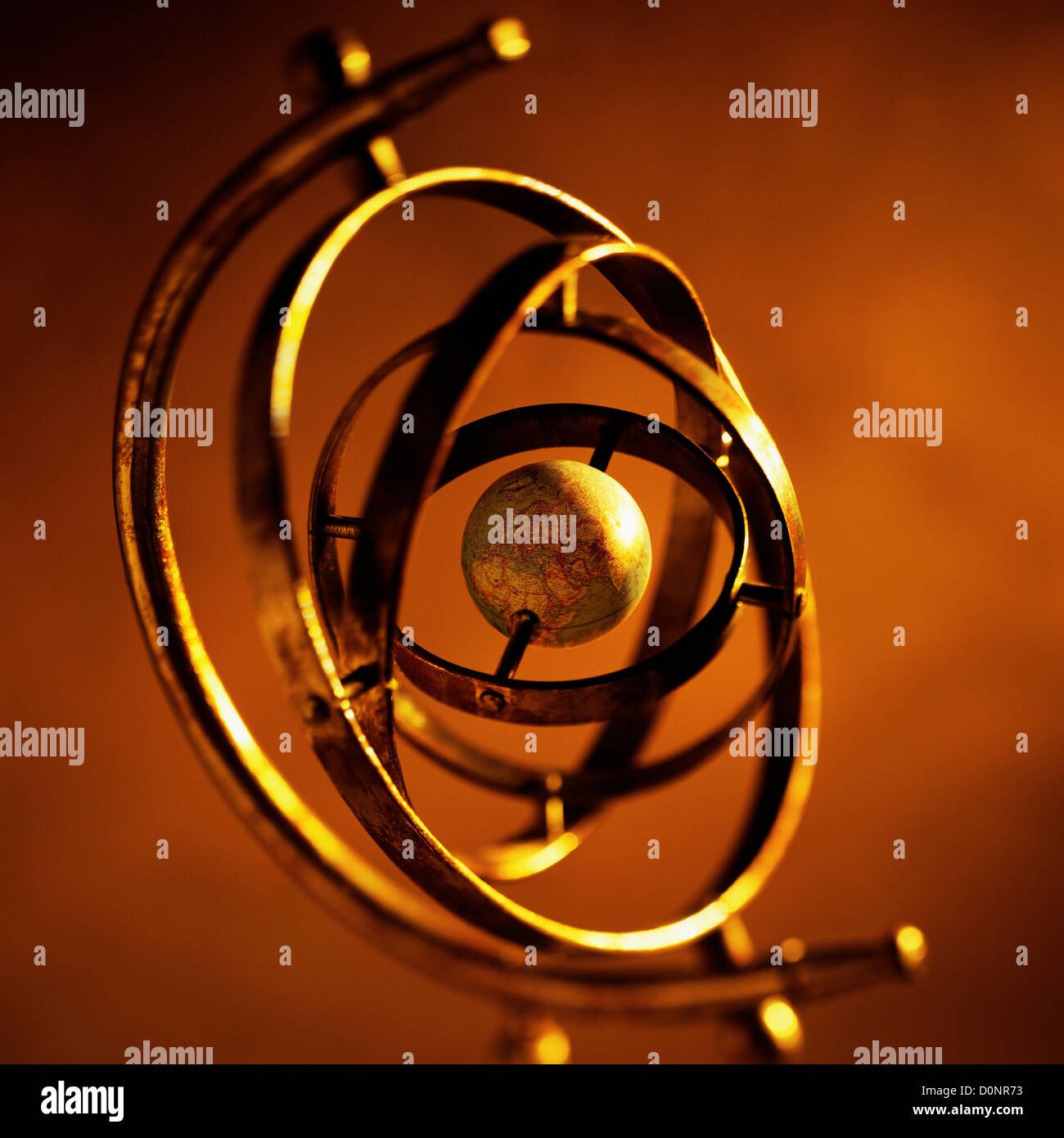 Concentric Metal Rings of an Armillary Sphere Rotate Around a Central Globe Stock Photo