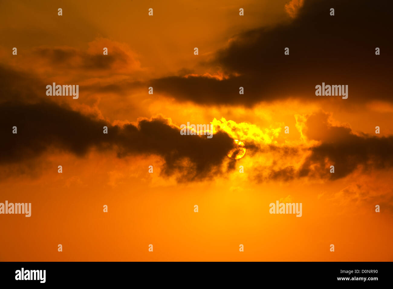 Beautiful orange sunset in a cloudy sky Stock Photo - Alamy