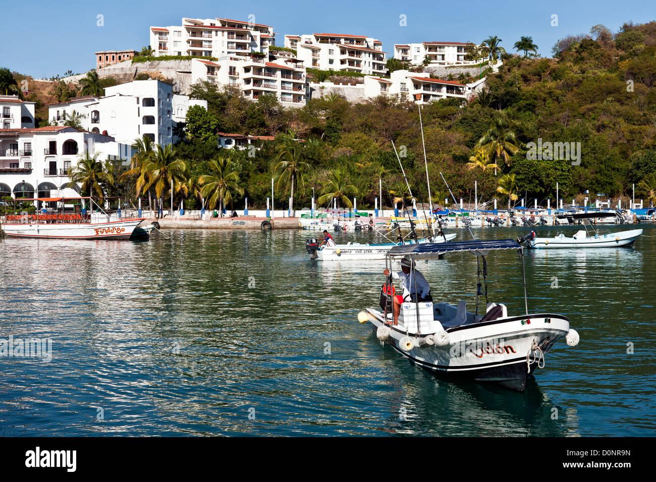 harbor with flotilla of excursion boats at port of Santa Cruz bahia de Santa Cruz planned tourist development Huatulco Mexico Stock Photo