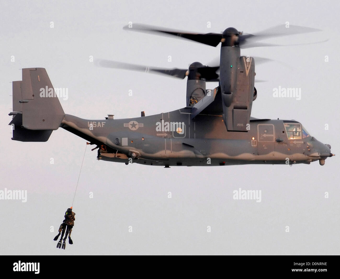 CV-22 Osprey Hauling in Navy SEALs Stock Photo