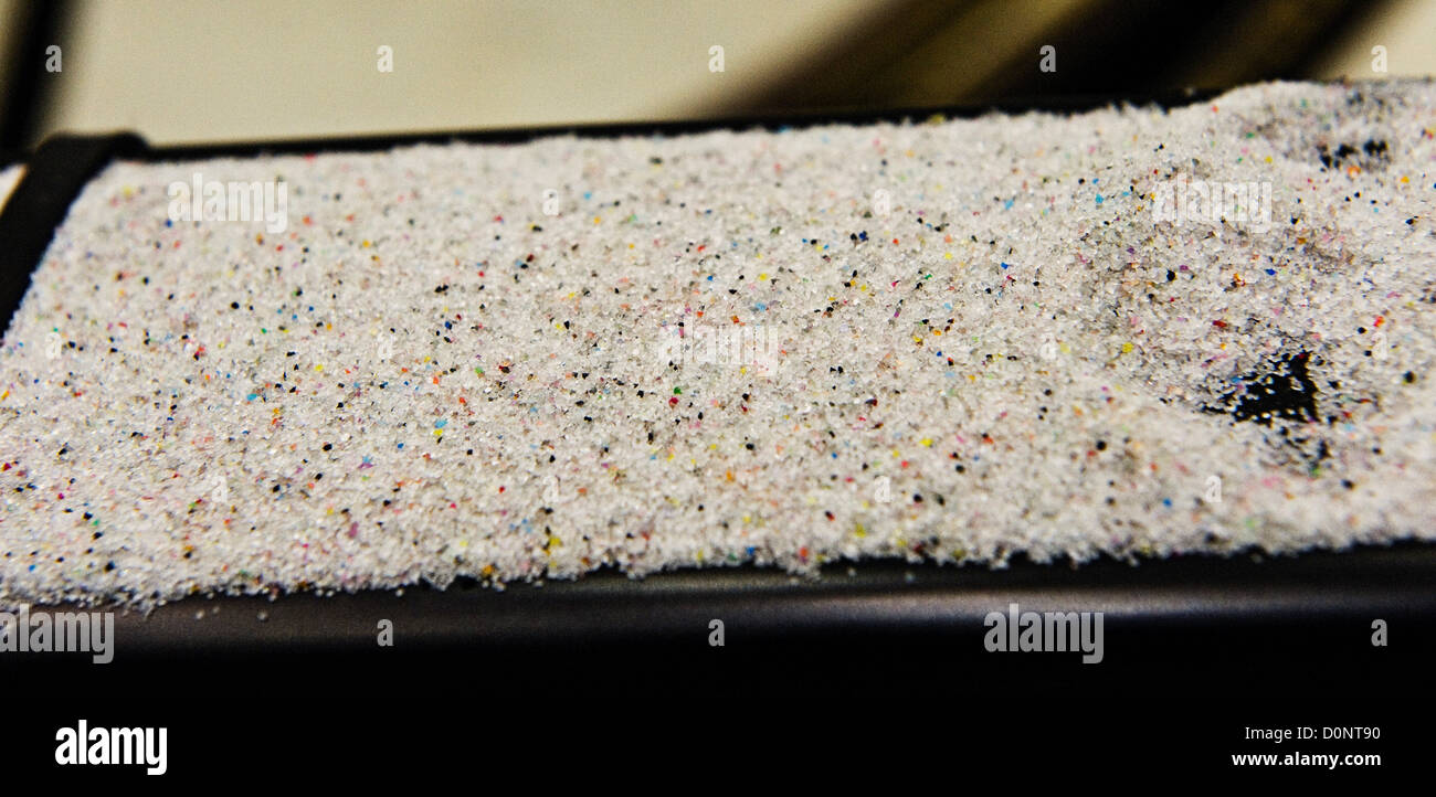 Sand - actually tiny plastic beads - colorful pieces what was aircraft paint are remainders aircraft depainting process  402 Stock Photo