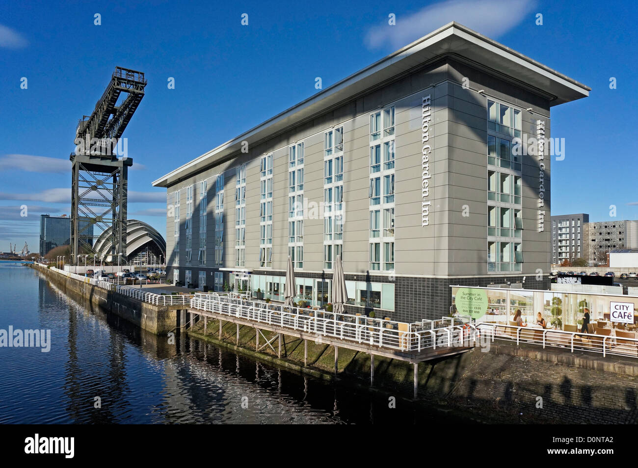 Hilton Garden Inn at the River Clyde in Glasgow with Finnieston Crane and Clyde Auditorium on a sunny autumn day Stock Photo