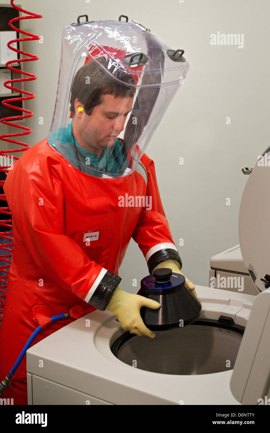 While wearing his air tight safety suit in this 2007 image CDC microbiologist Dr. Scott Smith is in process placing rotor cuff Stock Photo