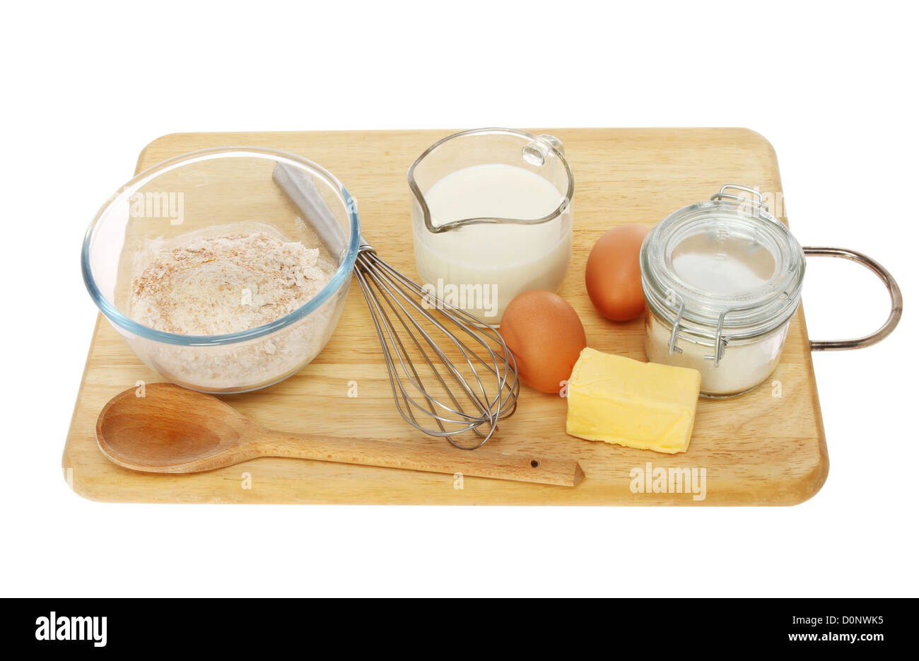 Baking ingredients and utensils on a wooden board isolated against white Stock Photo