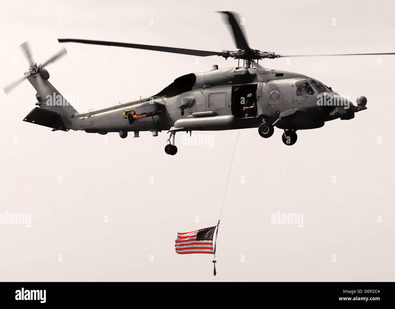 SH-60 Seahawk Flying American Flag Stock Photo