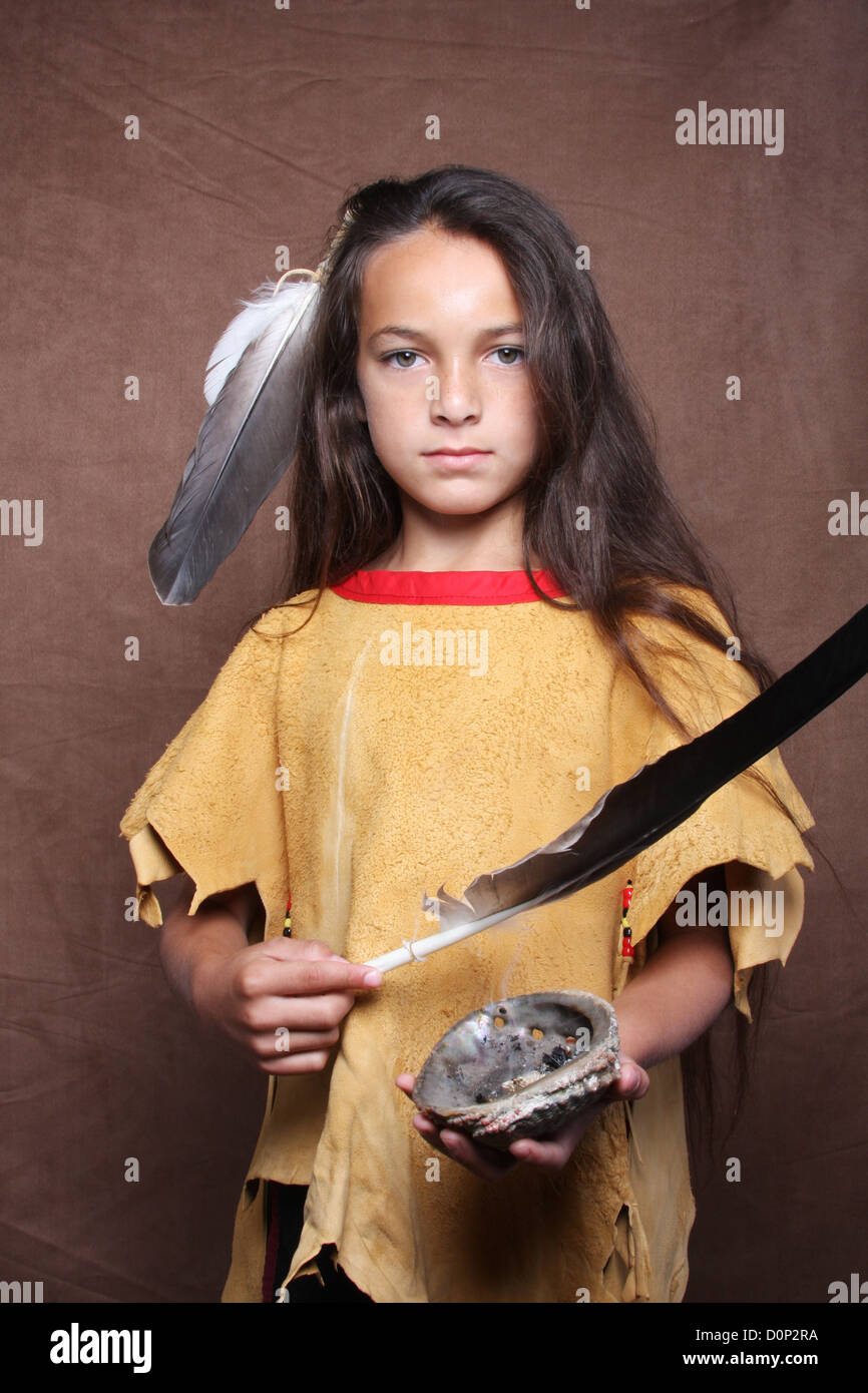 A Native American Indian boy Lakota Sioux smudging a sage offering