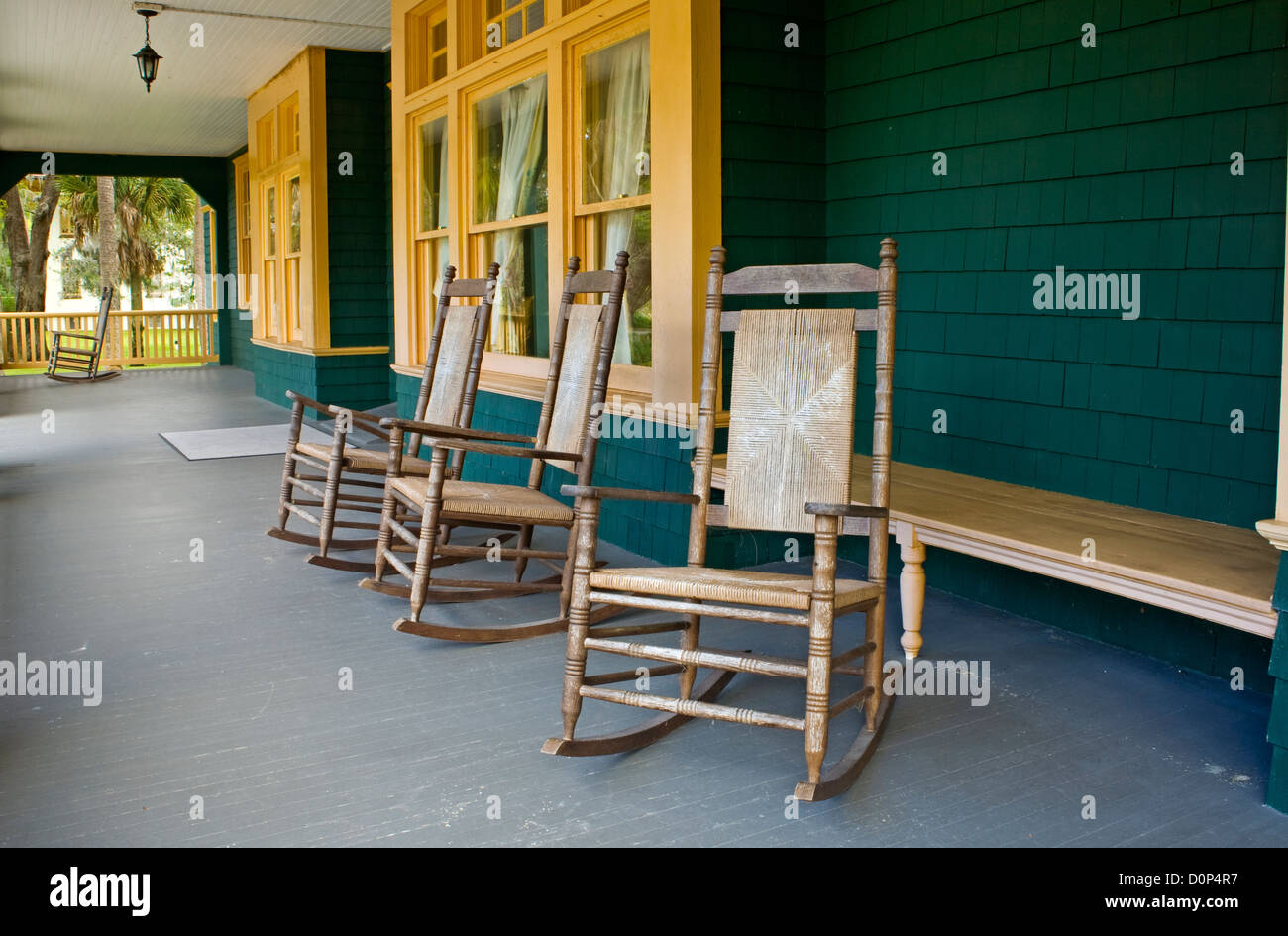 GA00118-00...GEORGIA - Rocking chairs on front porch of Moss Cottage in the historical district of Jekyll Island. Stock Photo