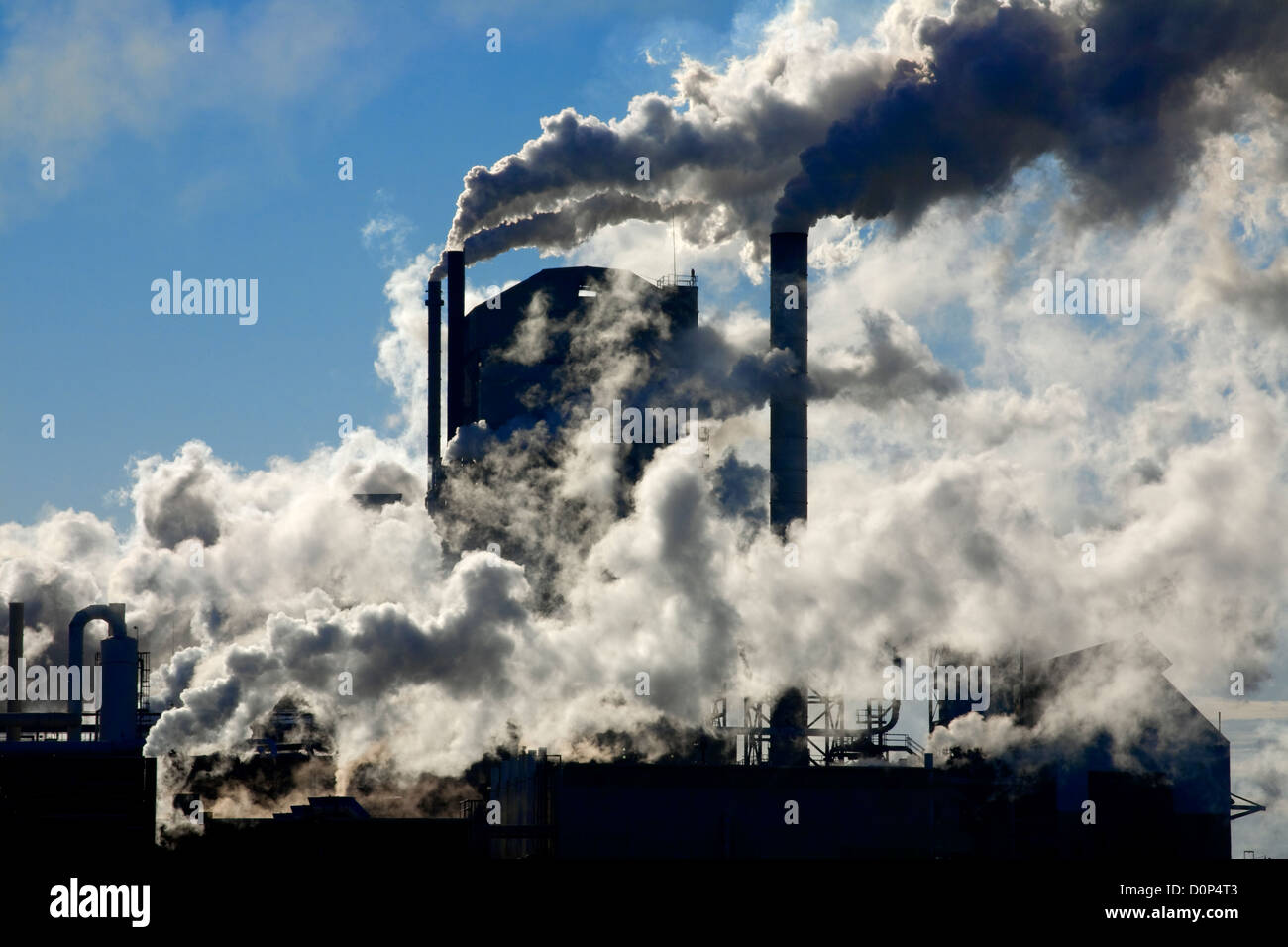 GA00128-00...GEORGIA - Smoke and steam issuing from multiple smokestacks at a fibers factory in the town of Jesup. Stock Photo