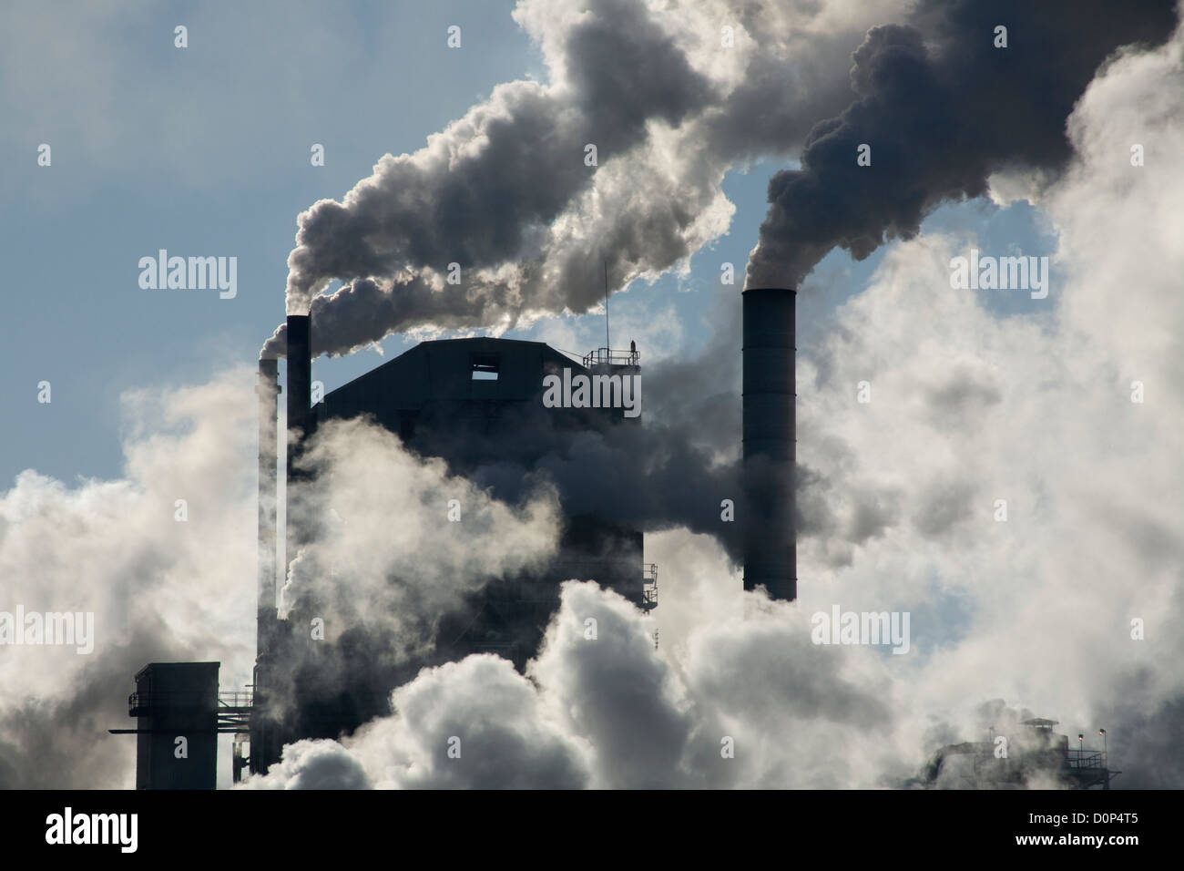 GA00129-00...GEORGIA - Smoke and steam issuing from multiple smokestacks at a fibers factory in the town of Jesup. Stock Photo