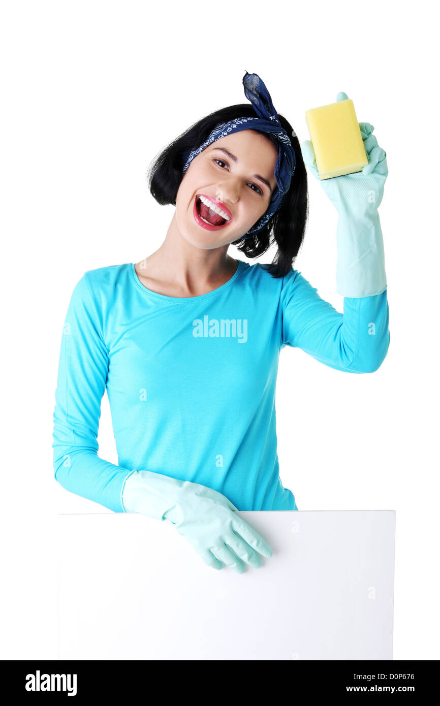 Smiling happy cleaning woman showing blank sign board.  Stock Photo