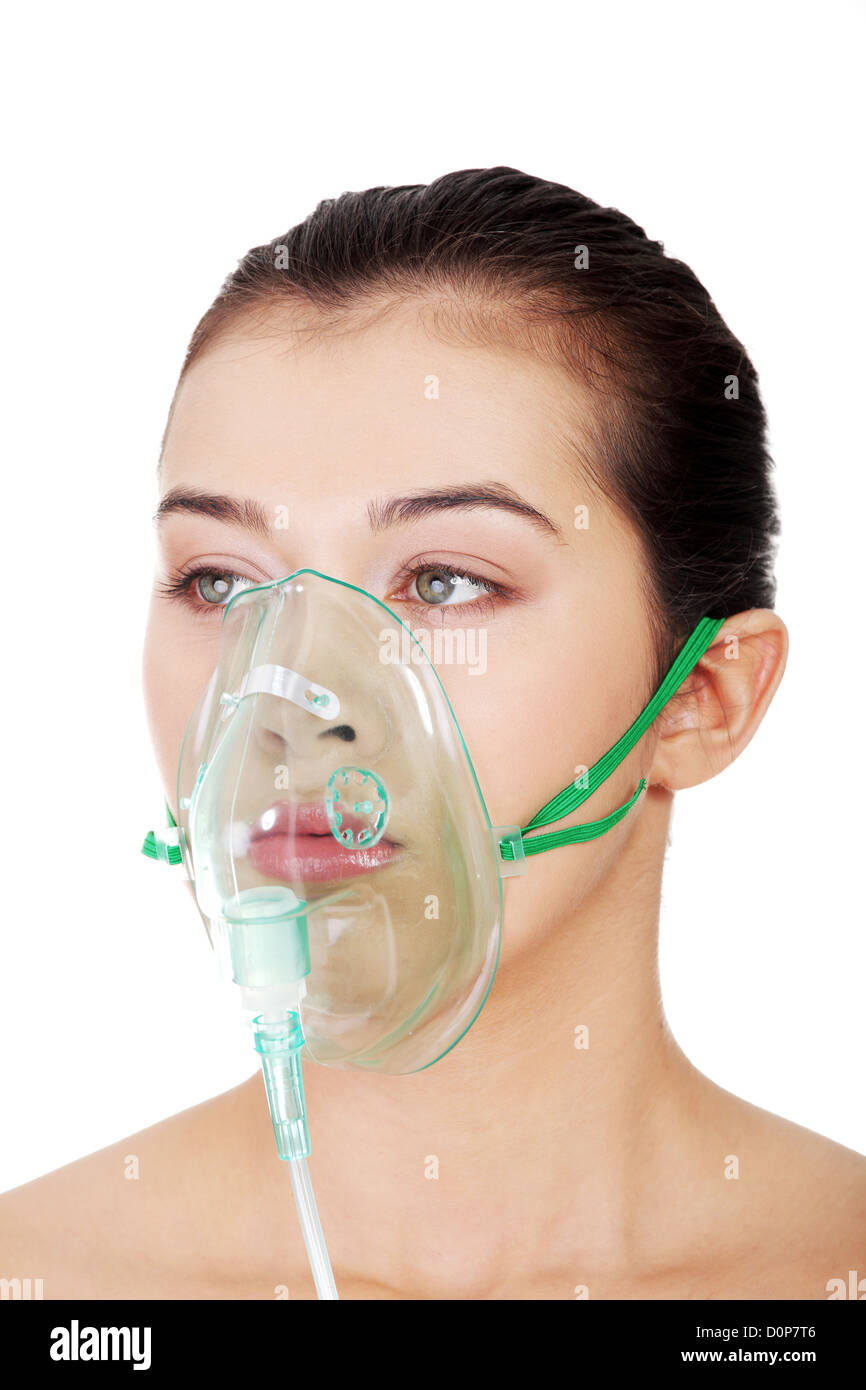 Diseased female patient wearing a oxygen mask against white background