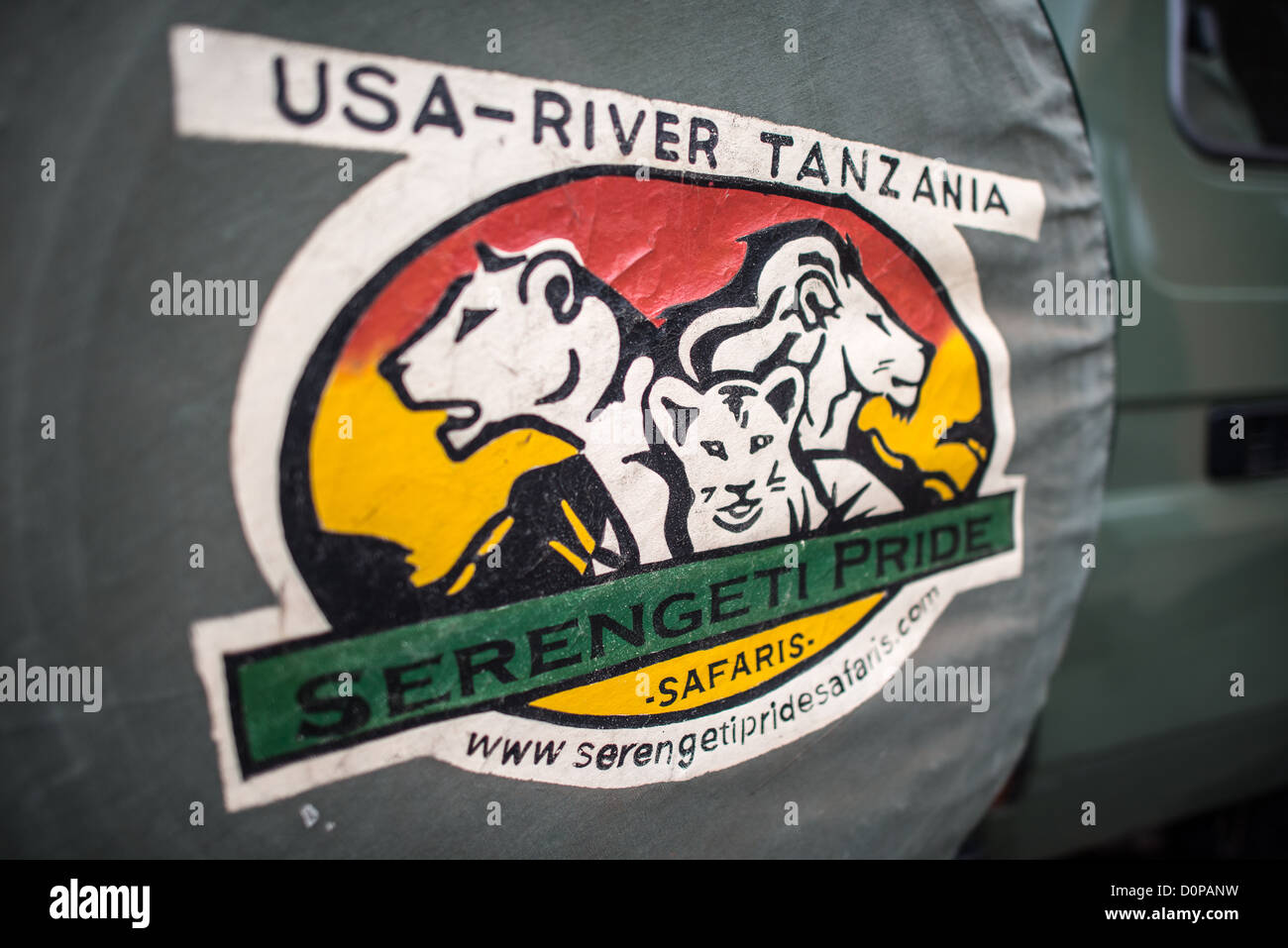 MT KILIMANJARO, Tanzania - The logo of Serengeti Pride, a travel and guide company for Mt Kilimanjaro. The shot is of the tire cover on the back of one of their Toyota Landcruisers. Stock Photo