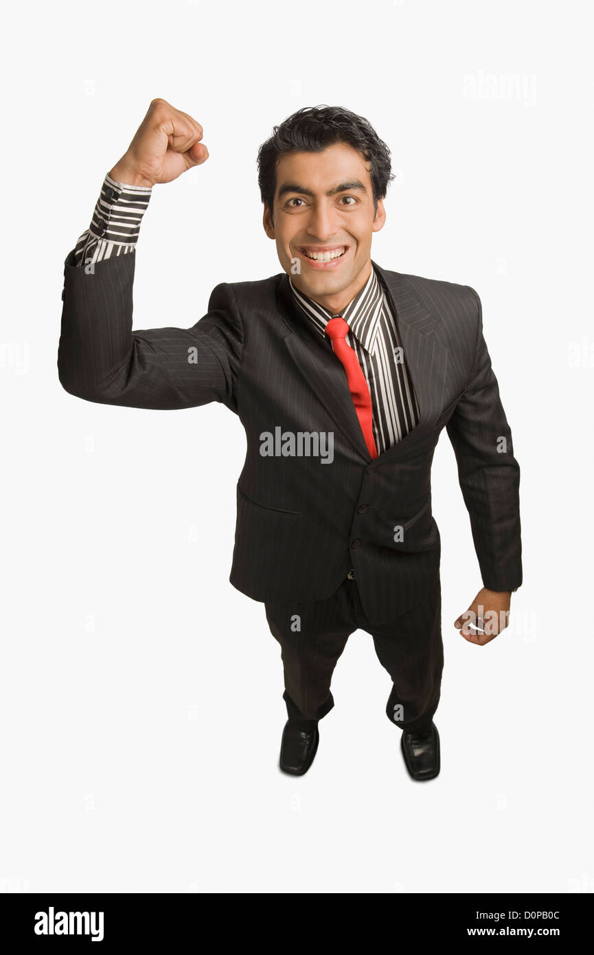 Businessman smiling with his hand raised Stock Photo - Alamy