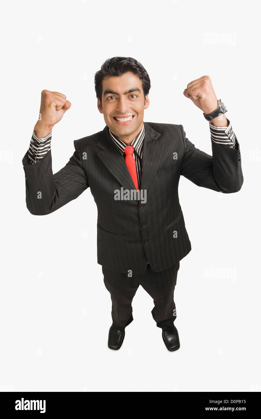 Businessman smiling with his arms raised Stock Photo - Alamy