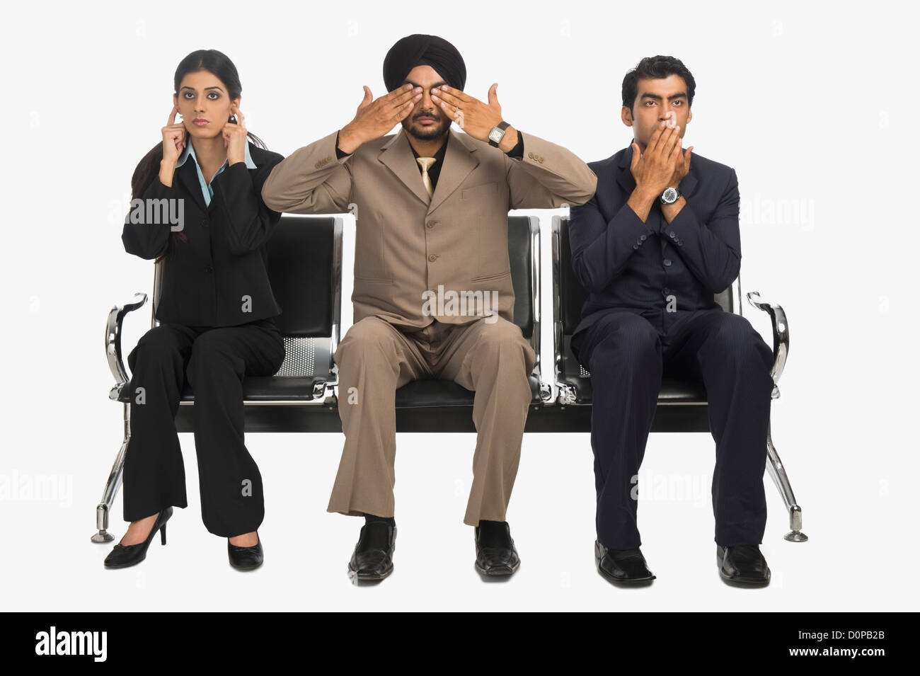 Business executives signing see no evil and speak no evil with hear no evil Stock Photo