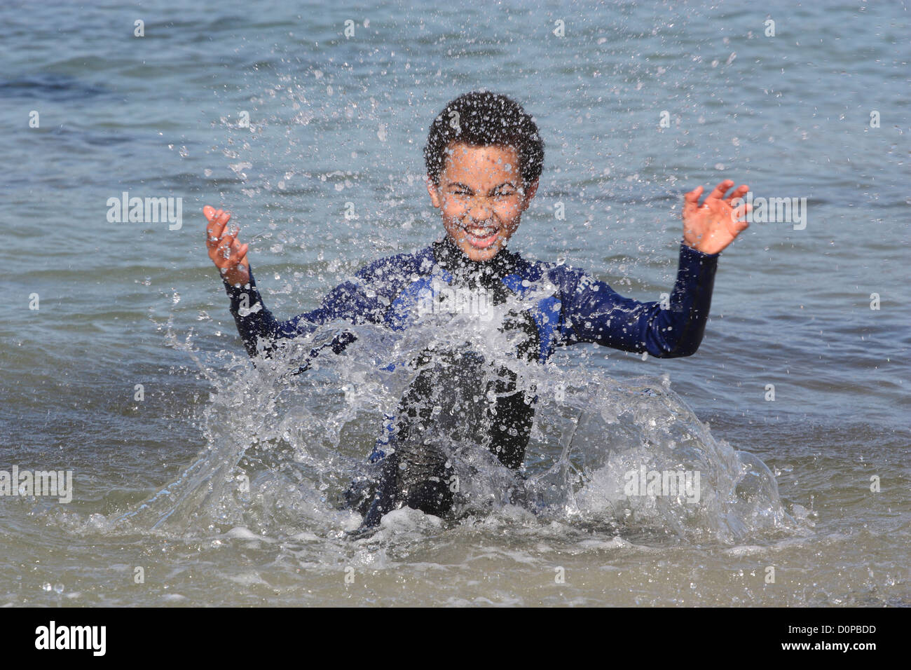 Young boy (11 years) outdoors splashing in the sea Stock Photo - Alamy