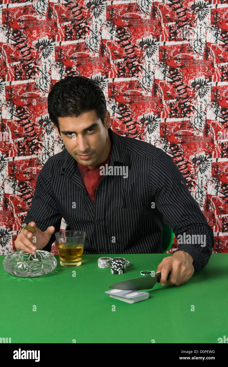 Man smoking and drinking at a casino table Stock Photo Alamy