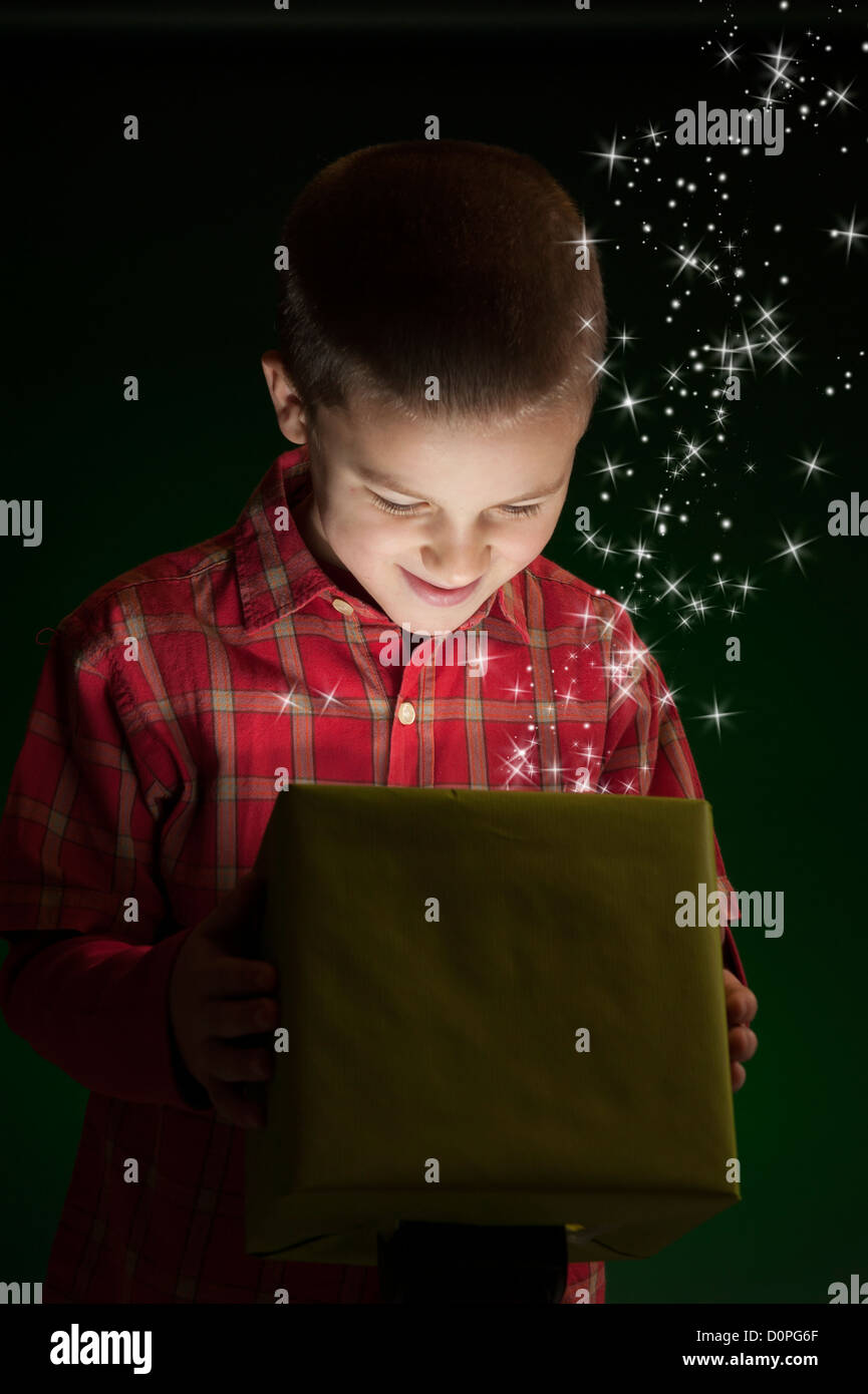 boy with present, light coming out of the box Stock Photo Alamy