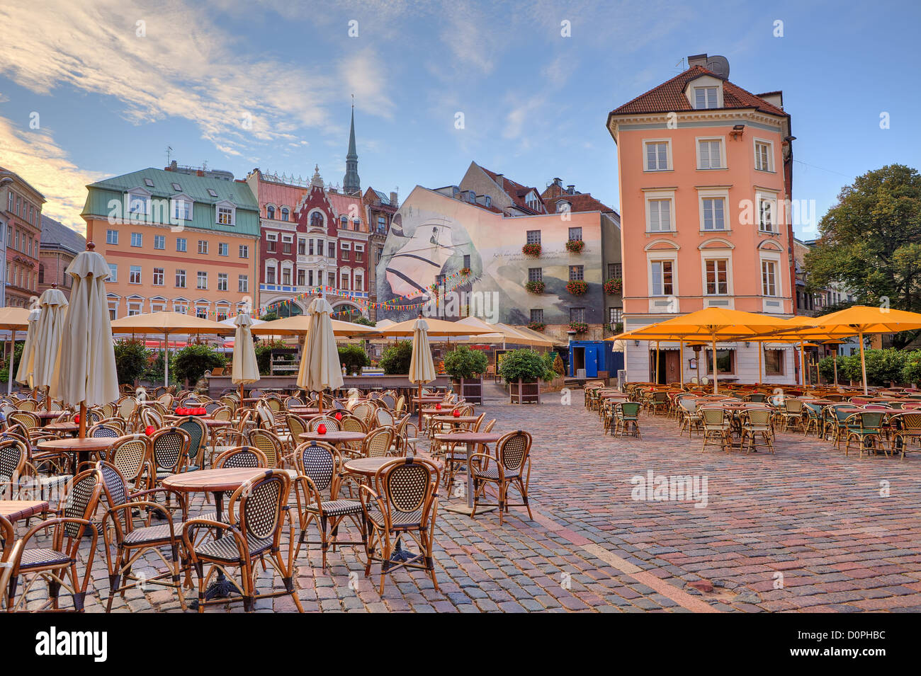 Cobbled city square with outdoor restaurants among colorful buildings in Riga, Latvia. Stock Photo