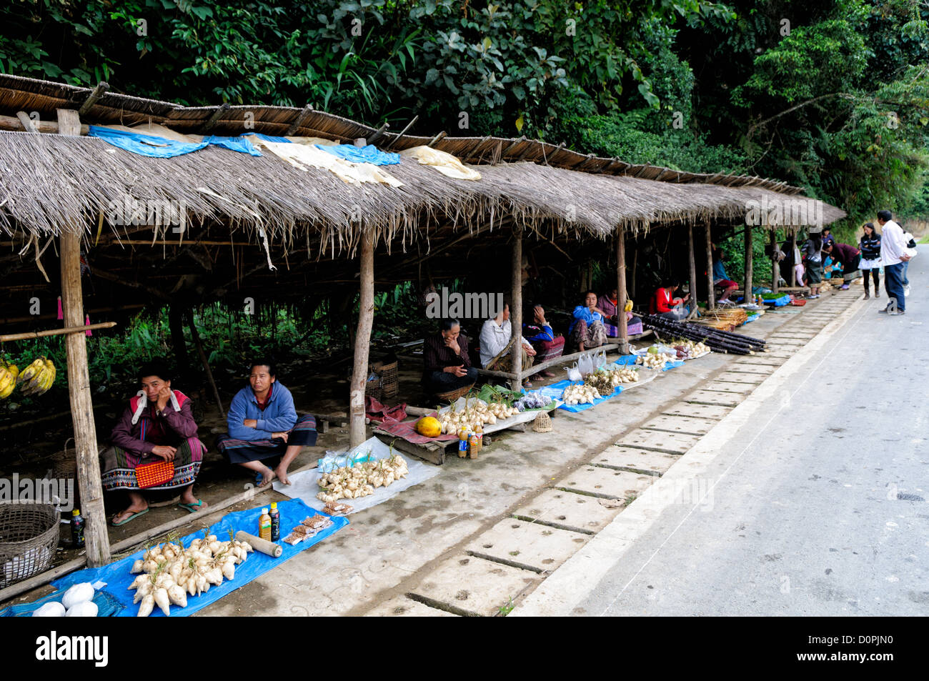 LUANG NAMTHA, Laos - A roadside market where vendors sell food and other items in Luang Namtha province in northern Laos. Stock Photo