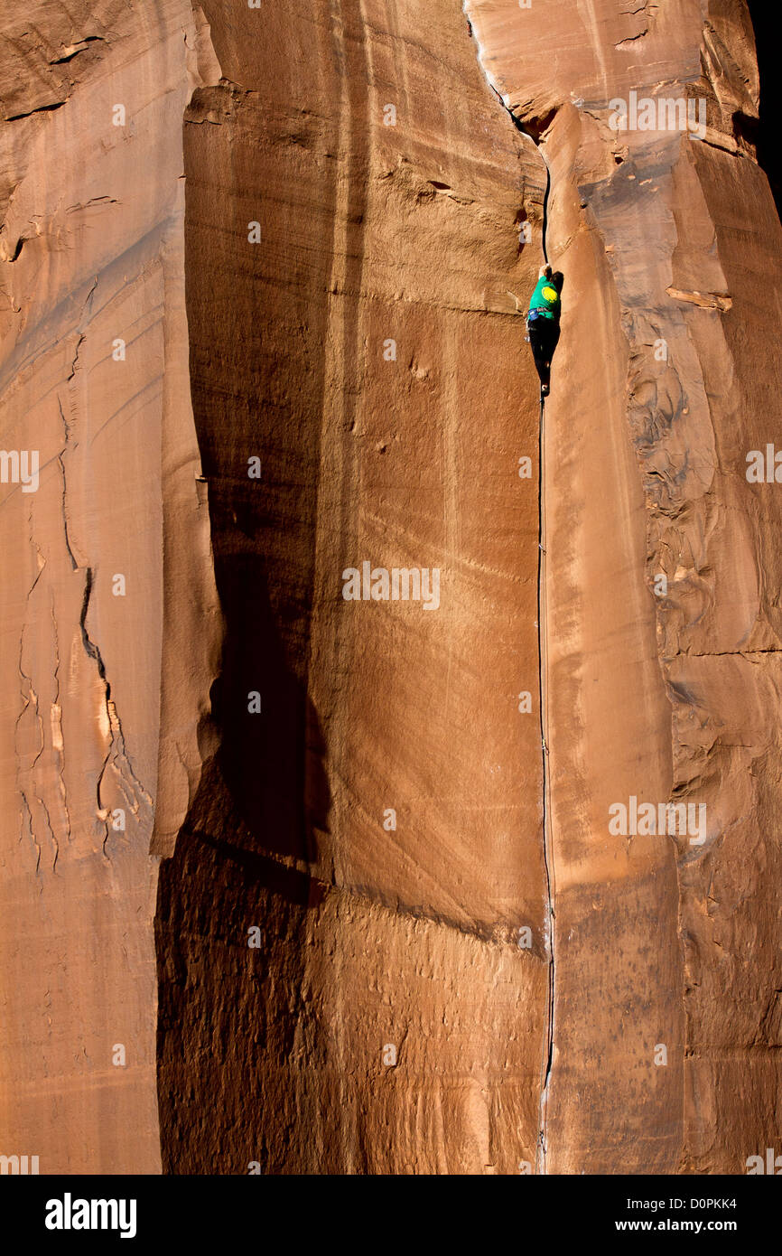 A man rock climbing a crack in Indian Creek, near Moab, Utah USA Stock Photo