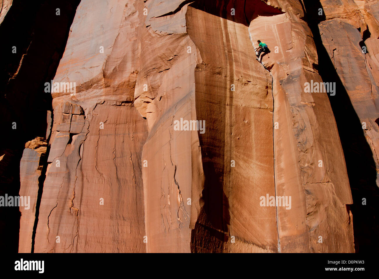 A man rock climbing a crack in Indian Creek, near Moab, Utah USA Stock Photo