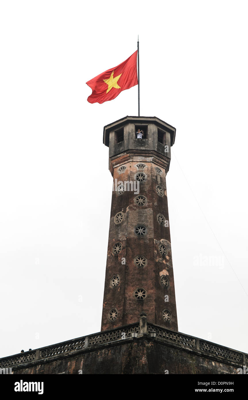 HANOI, Vietnam - HANOI, Vietnam - The Hanoi Flag Tribune is a centerpiece of the Vietnam Military History Museum. The tower was built in the early 19th century (1805-1812) and stands 33.5 meters tall. A 54-step spiral staircase leads to the top, where there is a small viewing room. A national flag has flown atop the tower night and day since October 10, 1954, after the defeat of the French at Dien Bien Phu. The monument has been designated by the Ministry of Culture and Information as a National Cultural and Historic Relic. The museum was opened on July 17, 1956, two years after the victory ov Stock Photo