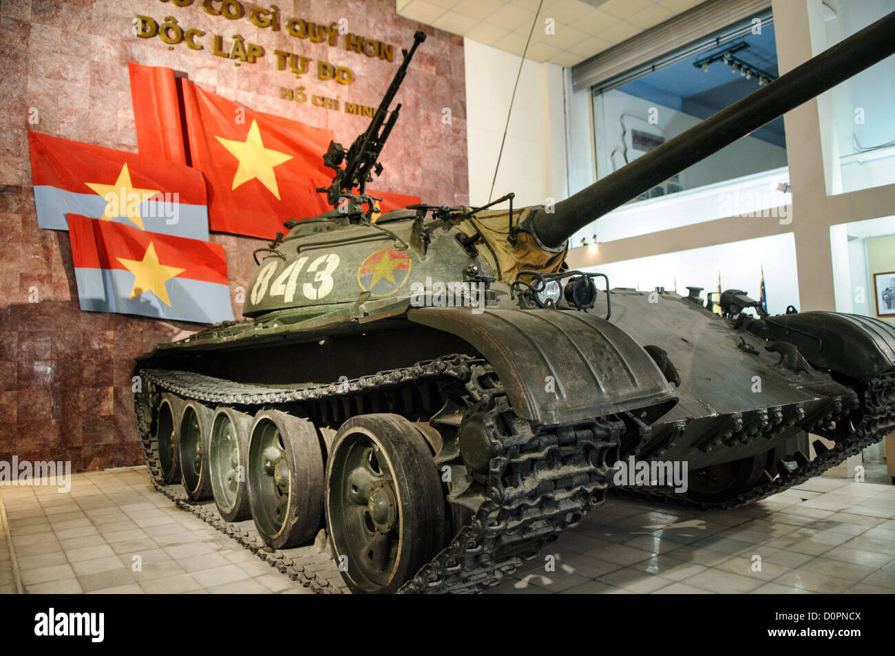 HANOI, Vietnam — A captured tank stands on display in the outdoor exhibition area of the Vietnam Military History Museum. This armored vehicle represents one of many pieces of military equipment preserved from the conflict period. The museum's collection includes numerous examples of captured military vehicles and equipment. Stock Photo