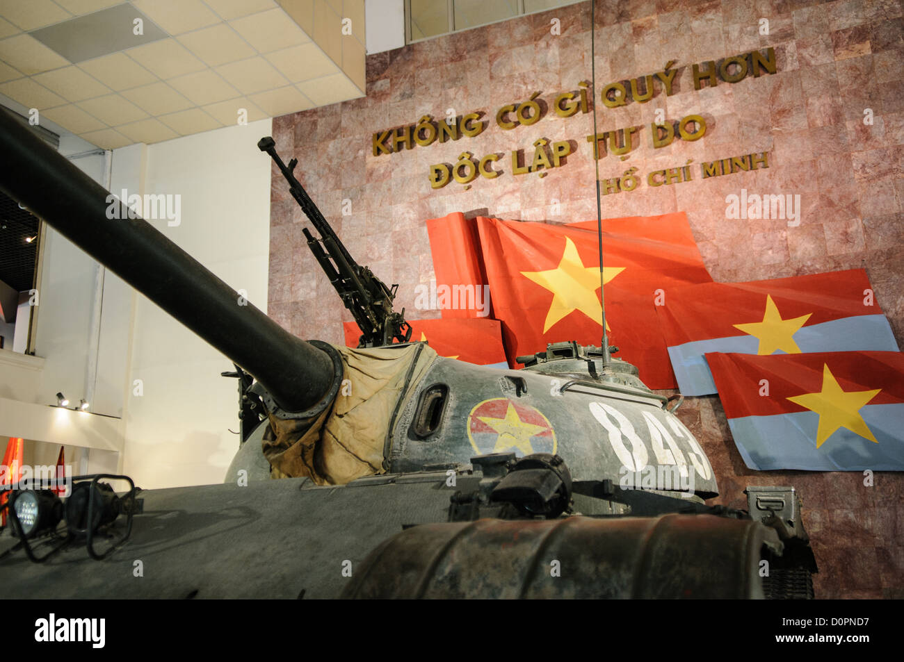 HANOI, Vietnam — A captured tank stands on display in the outdoor exhibition area of the Vietnam Military History Museum. This armored vehicle represents one of many pieces of military equipment preserved from the conflict period. The museum's collection includes numerous examples of captured military vehicles and equipment. Stock Photo