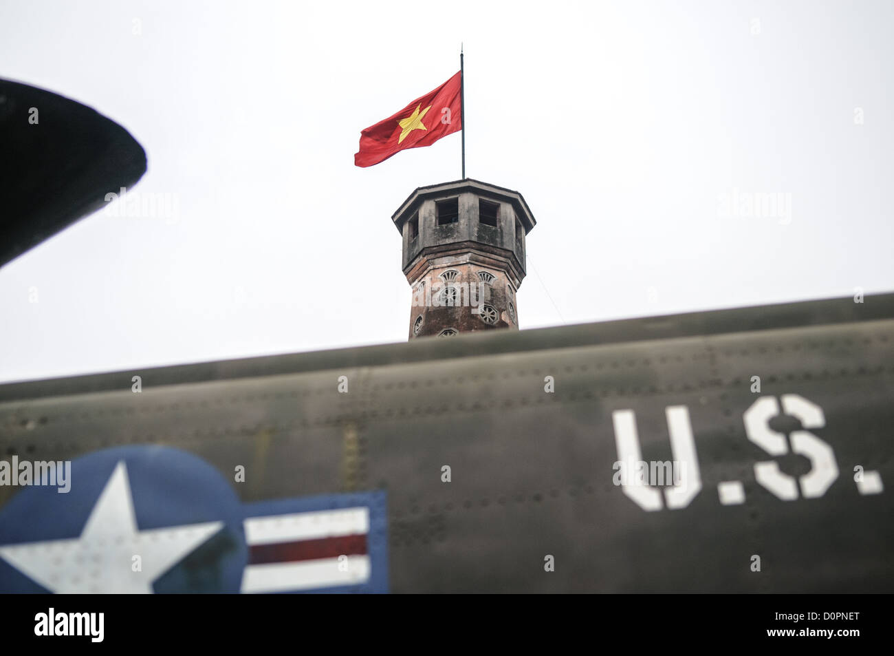 HANOI, Vietnam - HANOI, Vietnam - The Hanoi Flag Tribune is a centerpiece of the Vietnam Military History Museum. The tower was built in the early 19th century (1805-1812) and stands 33.5 meters tall. A 54-step spiral staircase leads to the top, where there is a small viewing room. A national flag has flown atop the tower night and day since October 10, 1954, after the defeat of the French at Dien Bien Phu. The monument has been designated by the Ministry of Culture and Information as a National Cultural and Historic Relic. The museum was opened on July 17, 1956, two years after the victory ov Stock Photo