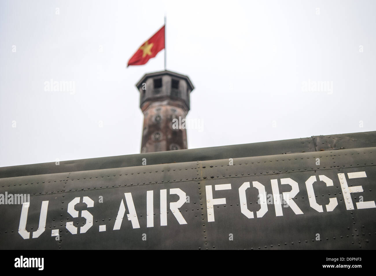 HANOI, Vietnam — A captured U.S. Air Force aircraft is displayed among other military equipment in the outdoor exhibition area of the Vietnam Military History Museum near the Flag Tower. The museum's collection includes various captured military hardware from the Vietnam War period. This display of war materiel stands as a testament to the conflict's scope and scale. Stock Photo