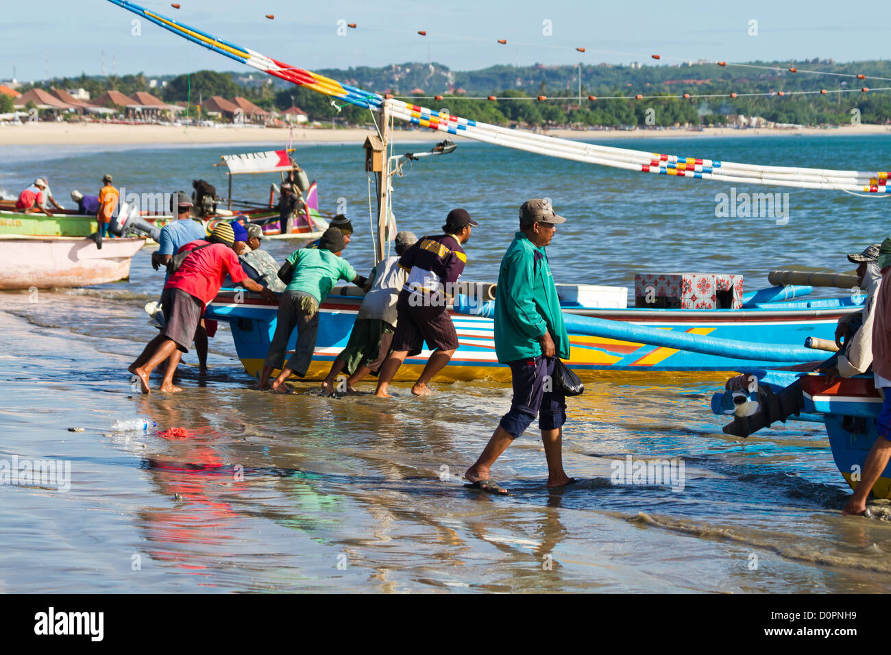 Muslim Fishermen at work at the Beach of Jimbaran on Bali, Indonesia Stock Photo