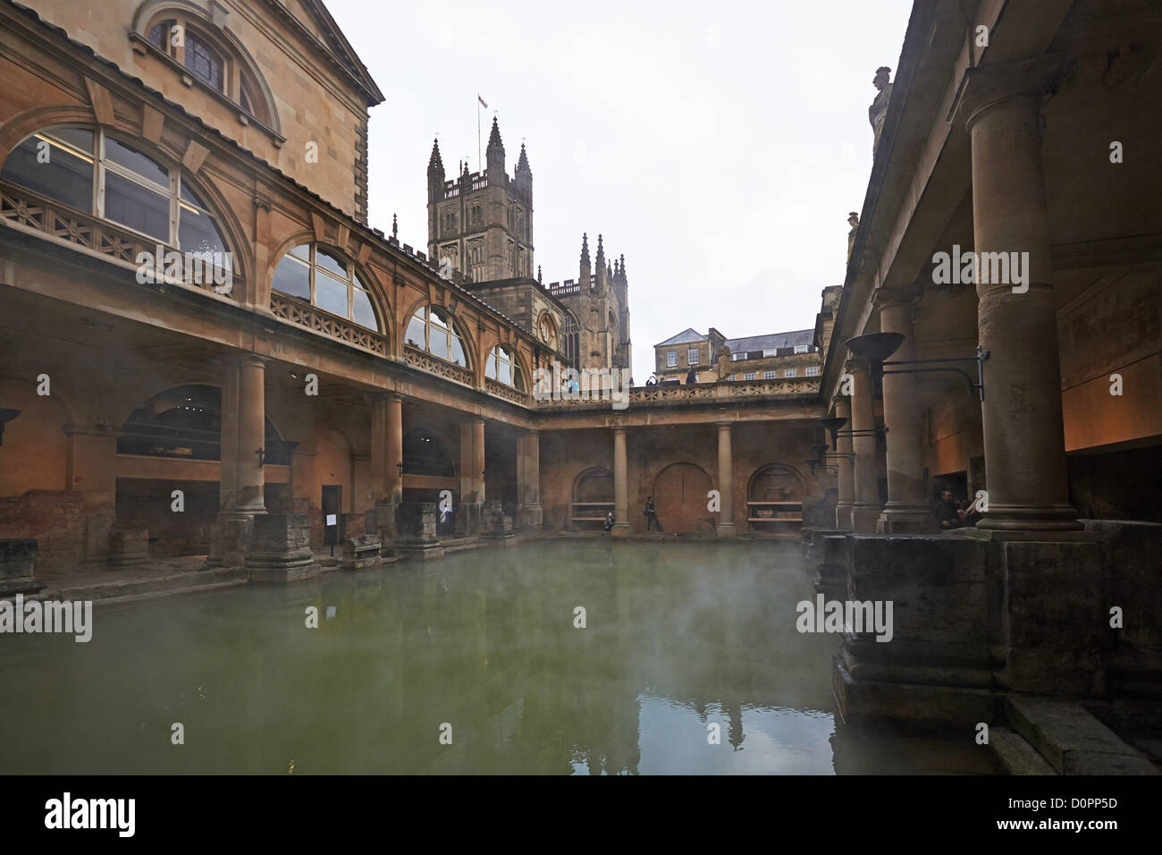 Bath Roman baths and a view of The Great Bath with Bath Abbey behind Stock Photo