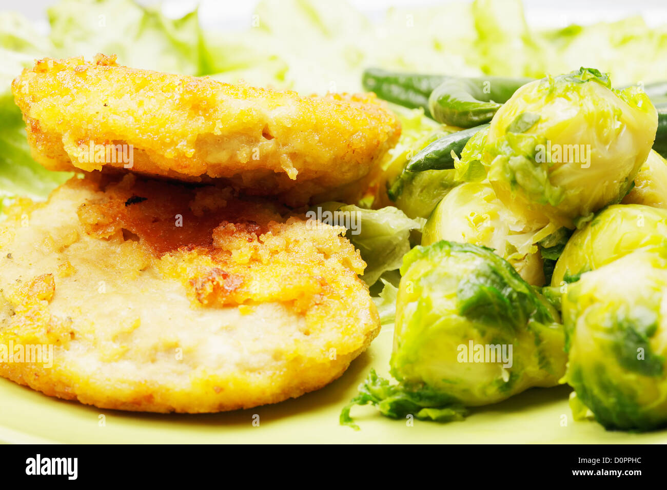 Breaded chicken cutlets and brussels sprouts Stock Photo Alamy