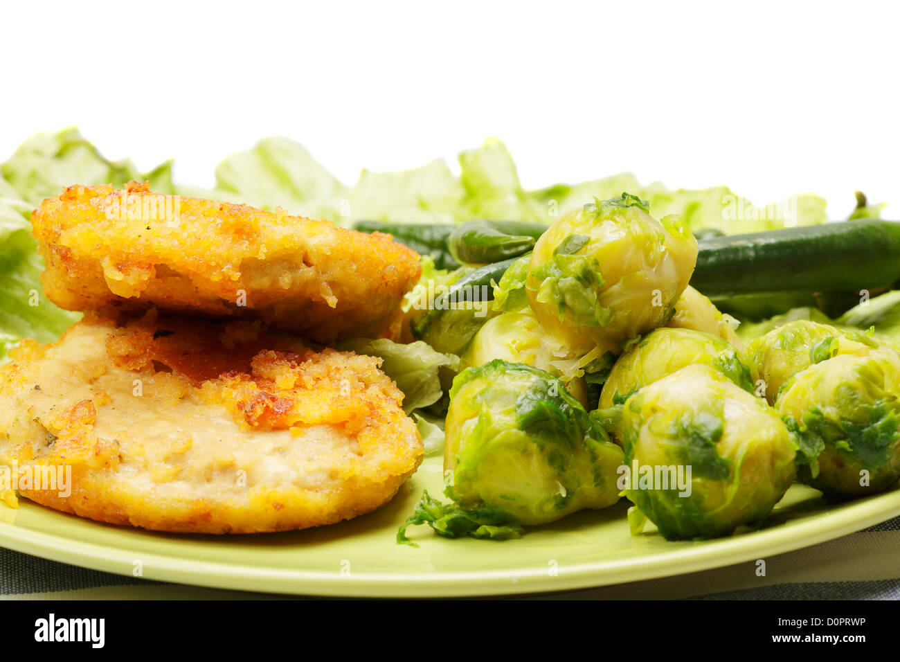 Breaded chicken cutlets with brussels sprouts Stock Photo Alamy