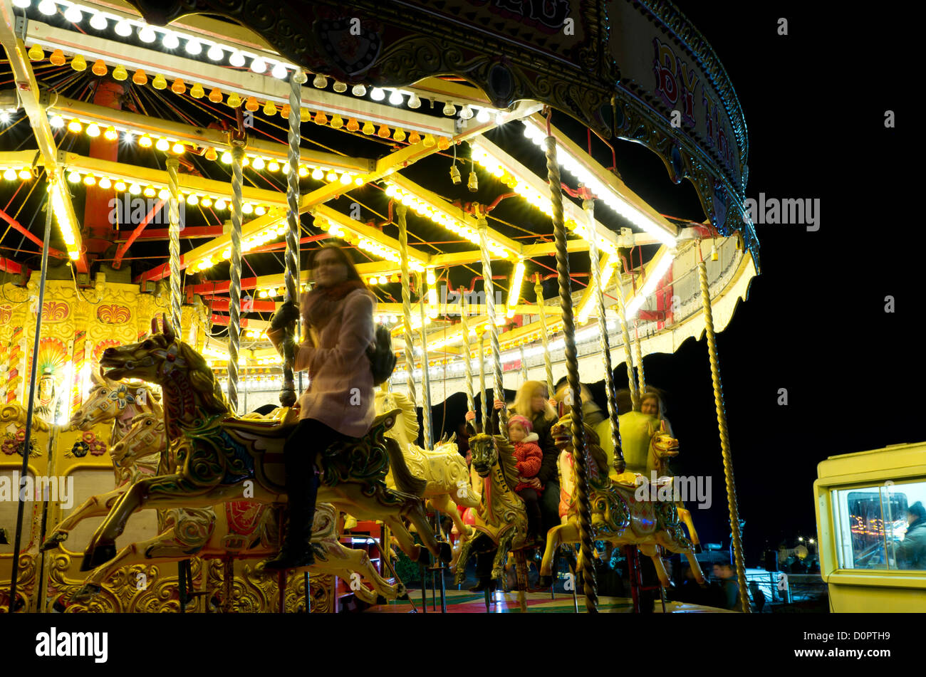 The Galloping Horses carousel in the fairground at the annual fireworks South Park, Oxford, UK Stock Photo