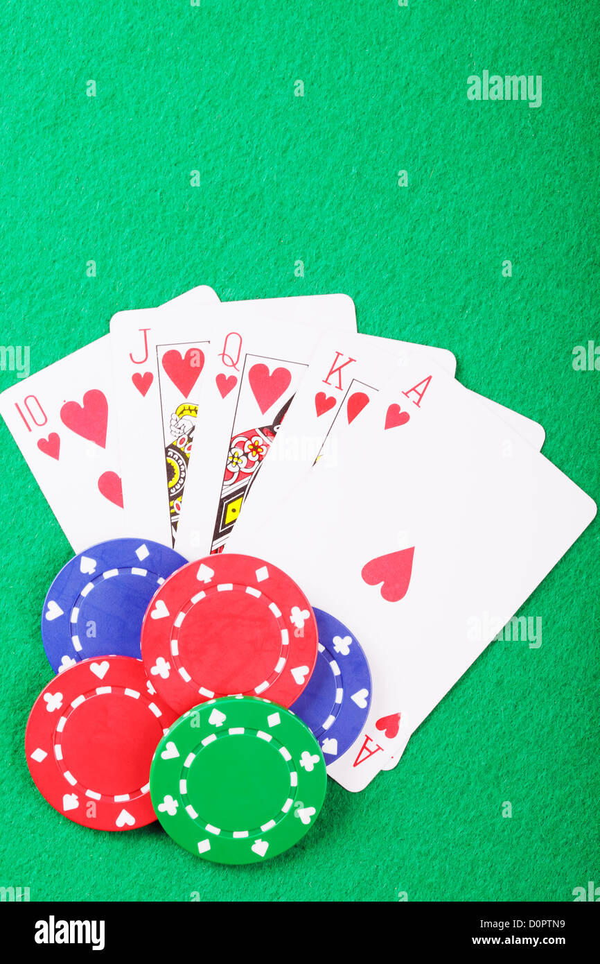 Poker chips on royal flush Stock Photo - Alamy