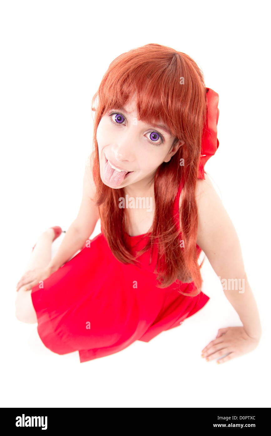 Young woman in red dress with tongue out Stock Photo