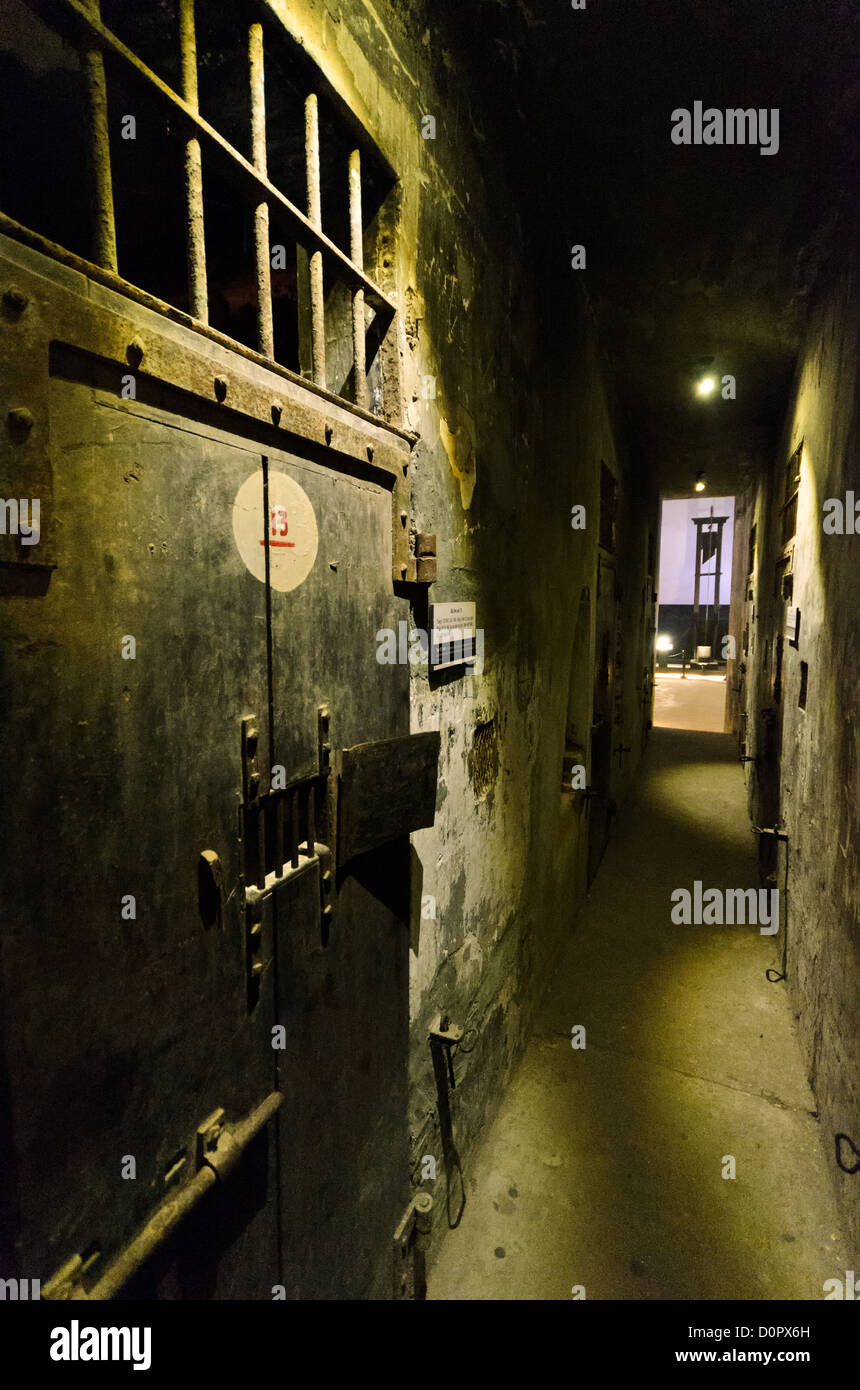 HANOI, Vietnam - View of the corridor along death row, where prisoners destined for execution were kept in isolation. At left is one of the reinforced doors of the cells. In the distance, down the corridor, is one of the guillotines that the French colonial government used for executions. Hoa Lo Prison, also known sarcastically as the Hanoi Hilton during the Vietnam War, was originally a French colonial prison for political prisoners and then a North Vietnamese prison for prisoners of war. It is especially famous for being the jail used for American pilots shot down during the Vietnam War. Stock Photo