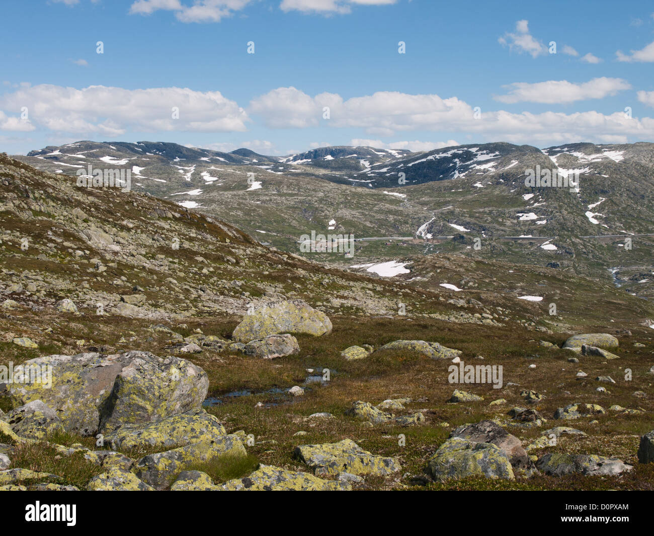 Mountain panorama from a hiking path on Hardangervidda Norway with view of the railway line Oslo Bergen and Hallingskeid station Stock Photo