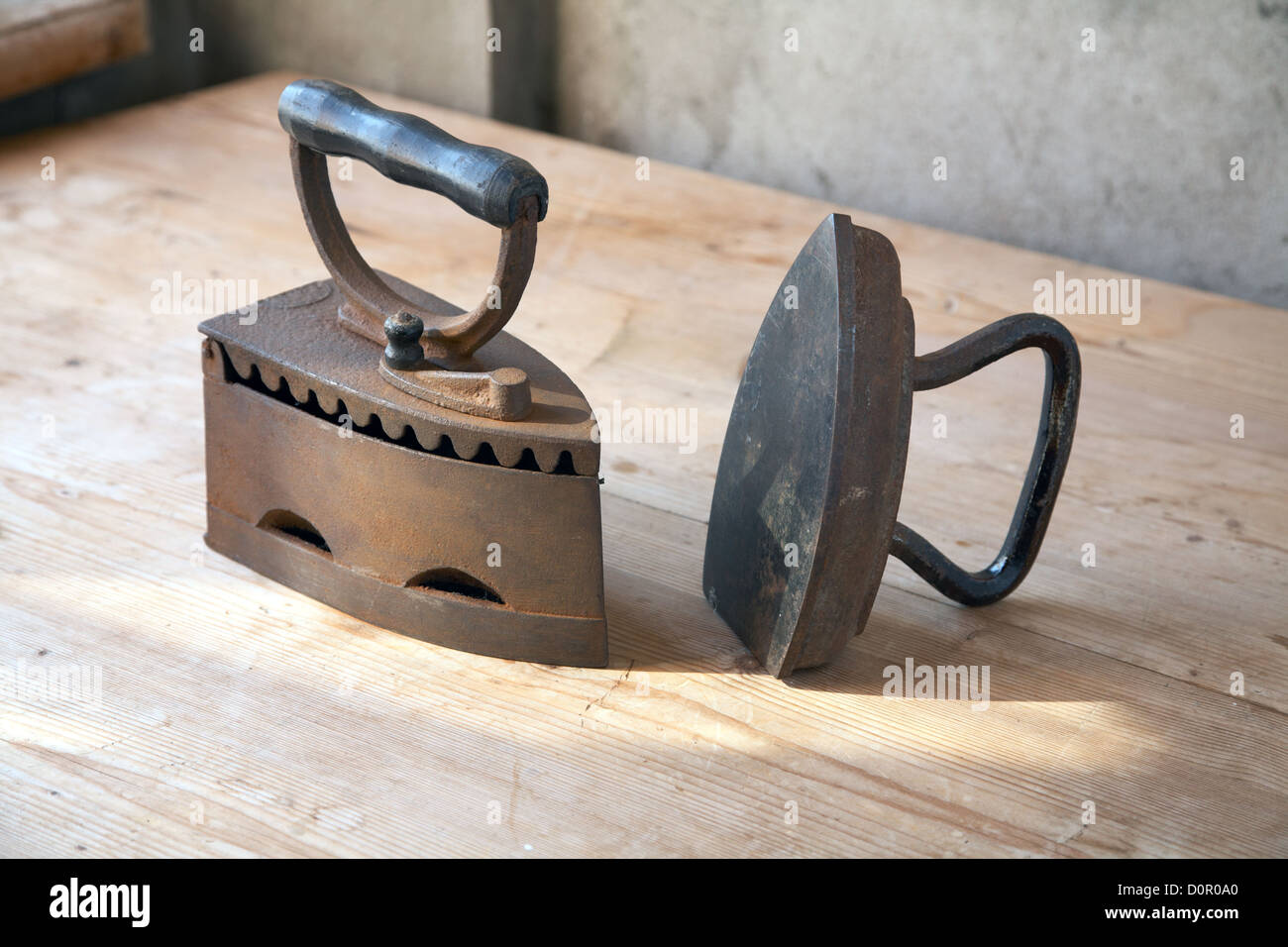 Two old irons on a table Stock Photo Alamy